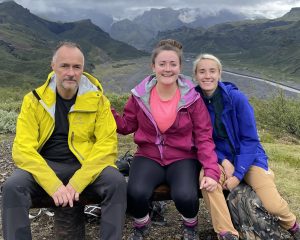 Lauren and Becky on a mountainside with their father.