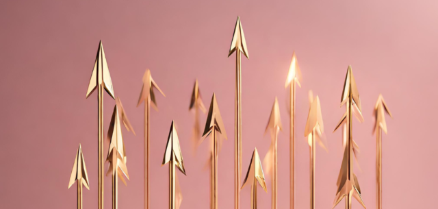 A row of gold arrows on a pink background